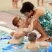 Buhr Park Shark Toby Peters, 7, reaches out of the pool to hug his mom Amina as he takes a break from swimming laps to raise funds for Ann Arbor Active Against ALS and Bob Schoeni at the Buhr Park Pool on Wednesday morning. Melanie Maxwell | AnnArbor.com